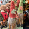 Decorative gnomes with autumn-themed clothing and accessories on a table.