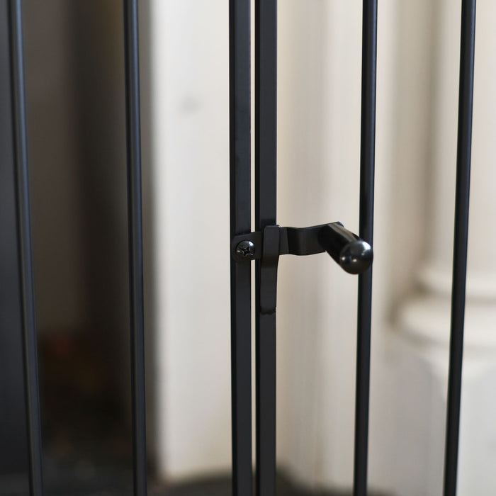 Close-up of a black metal gate with a blurred background