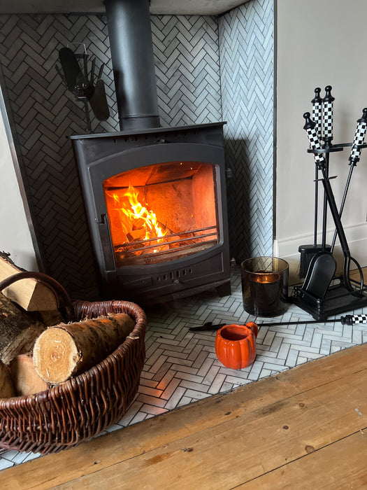 Checkered Fireside Tools Next to Log Burner 