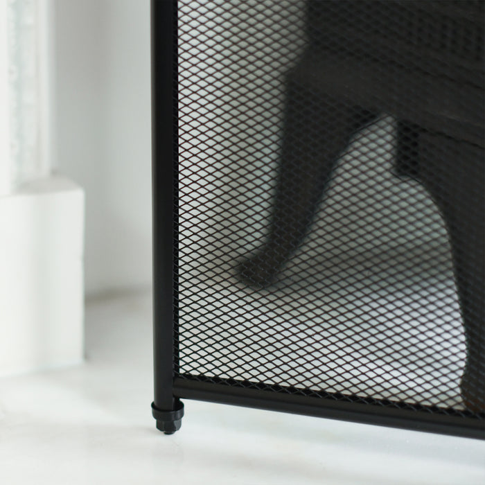Close Up Of Feet and Mesh On Fire Guard 