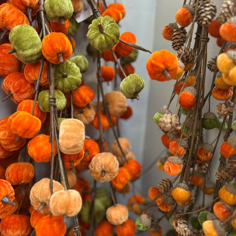 Decorative arrangement of pumpkins and gourds with a neutral background