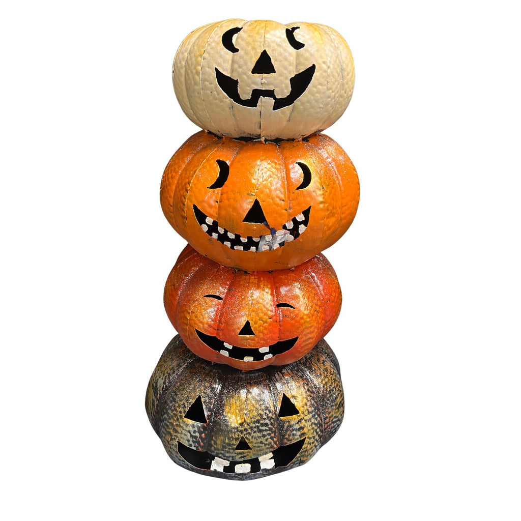 Stack of Halloween-themed pumpkins with jack-o'-lantern faces on a white background