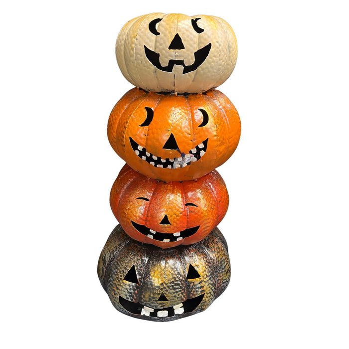 Stack of Halloween-themed pumpkins with jack-o'-lantern faces on a white background