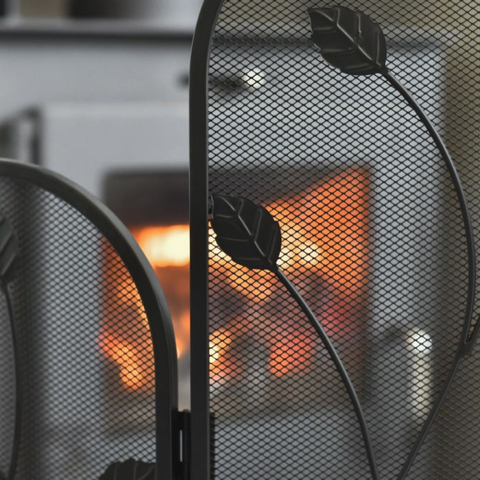 Fireplace with decorative screen and visible fire
