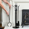 Model Demonstrating Tongs Next To Fireside