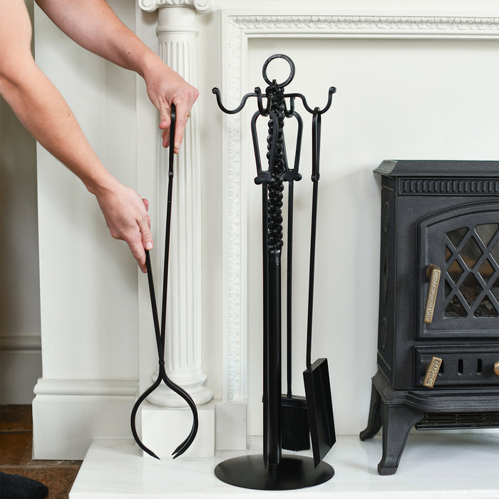 Model Demonstrating Tongs Next To Fireside
