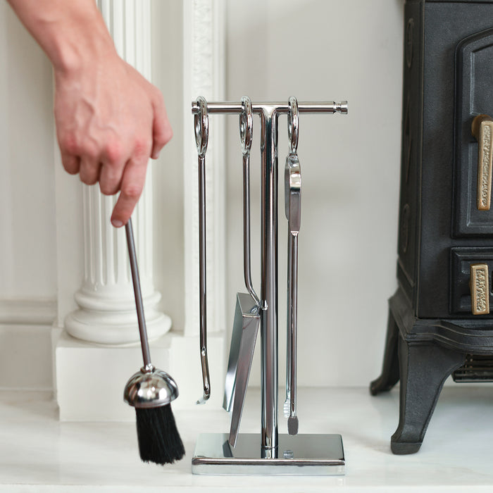 Silver Four Piece Fireside Tools Set with brush in use