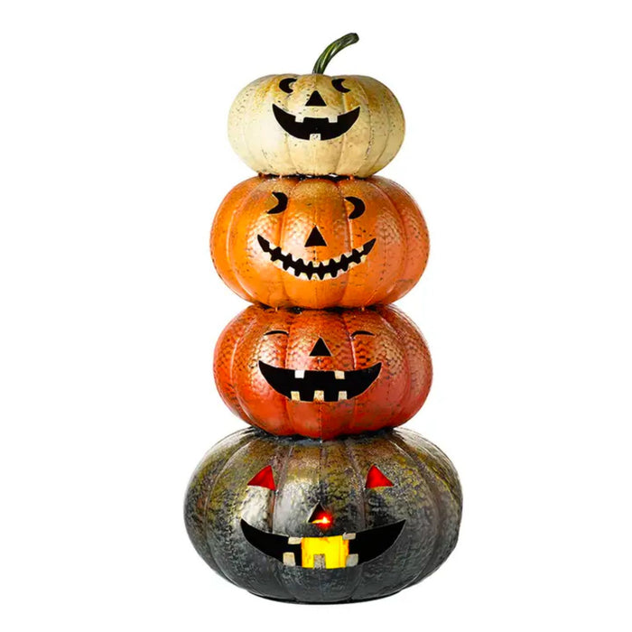 Stack of four Halloween pumpkins with carved faces on a white background